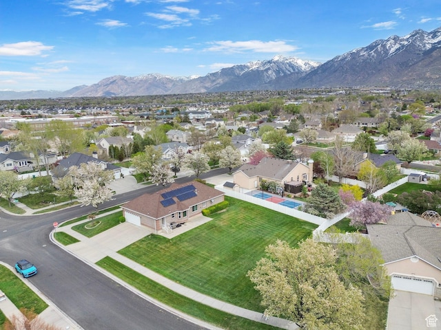 birds eye view of property with a mountain view and a residential view