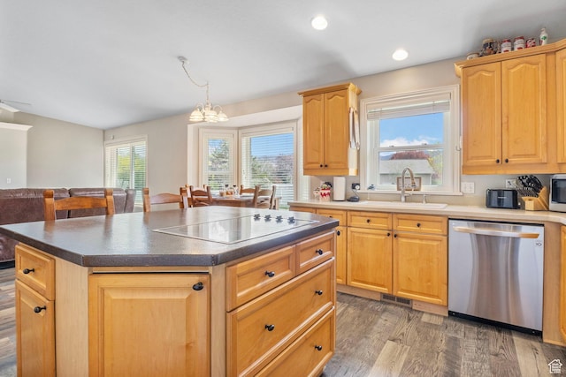 kitchen featuring a kitchen island, light wood-style floors, visible vents, appliances with stainless steel finishes, and a sink