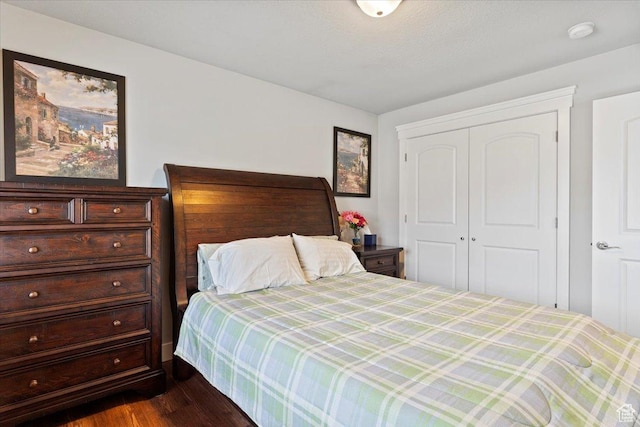 bedroom with a closet and dark wood-style floors