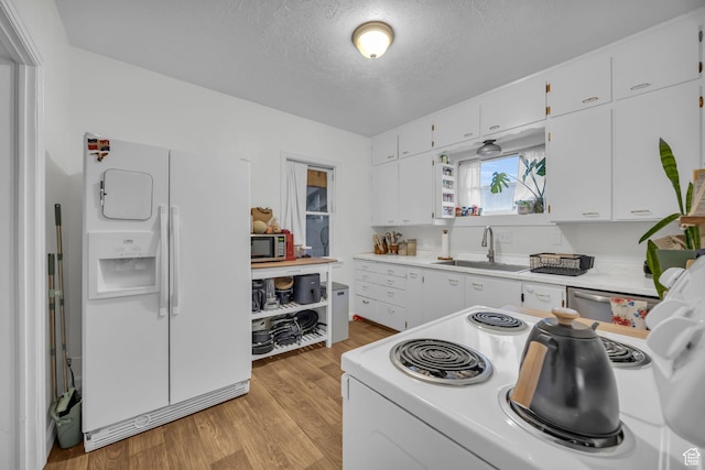kitchen featuring a sink, light countertops, white cabinetry, and stainless steel appliances
