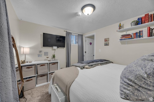 carpeted bedroom with a textured ceiling