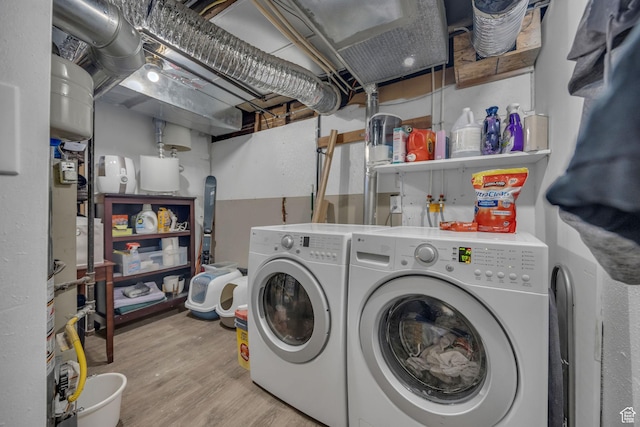 washroom featuring washer and dryer and wood finished floors