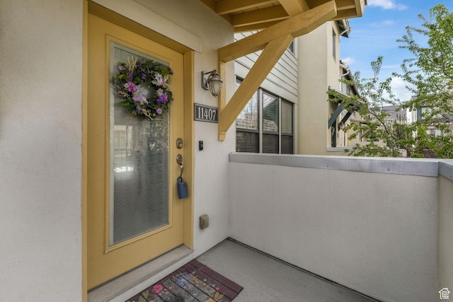 11407 S Oswego Ln, South Jordan, UT 84009 - property entrance featuring a balcony and stucco siding
