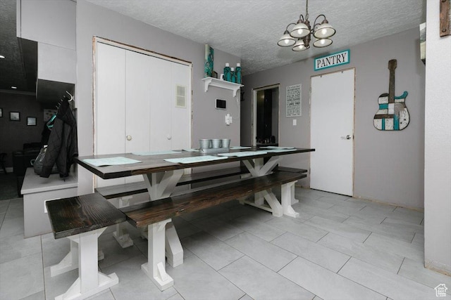 95 S 200 W, Lewiston, UT 84320 - dining space with a notable chandelier, a textured ceiling, and visible vents