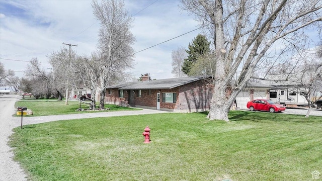 95 S 200 W, Lewiston, UT 84320 - ranch-style home featuring a chimney, a front yard, and brick siding