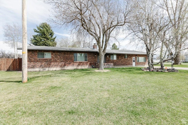 95 S 200 W, Lewiston, UT 84320 - view of front facade featuring a chimney, crawl space, a front lawn, brick siding, and fence