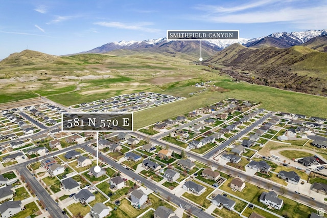 birds eye view of property with a mountain view and a residential view
