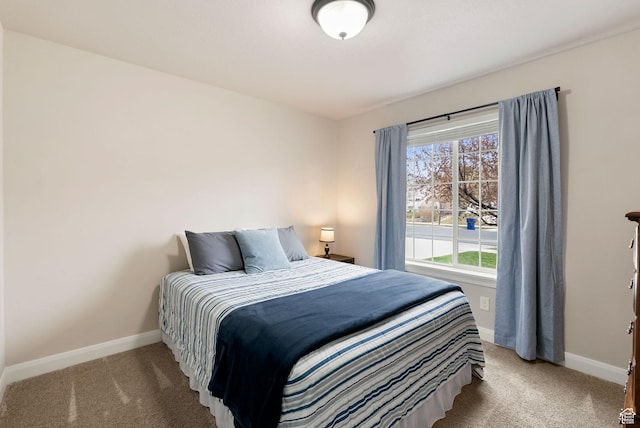carpeted bedroom featuring baseboards