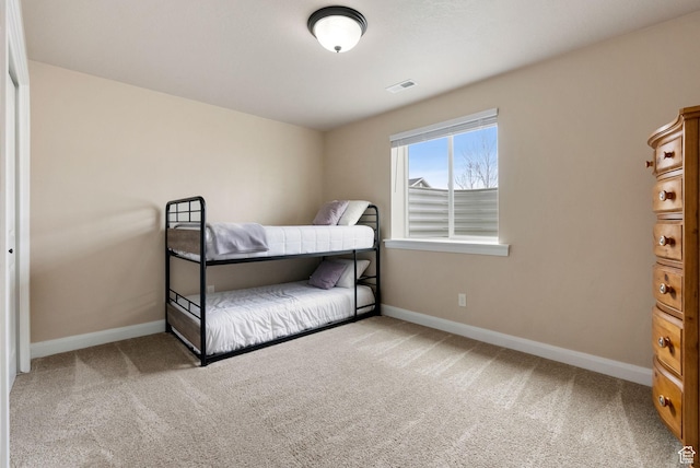bedroom with carpet, visible vents, and baseboards