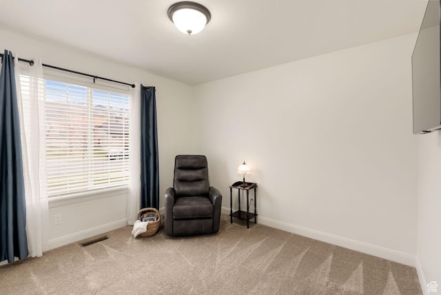sitting room featuring plenty of natural light, carpet, visible vents, and baseboards
