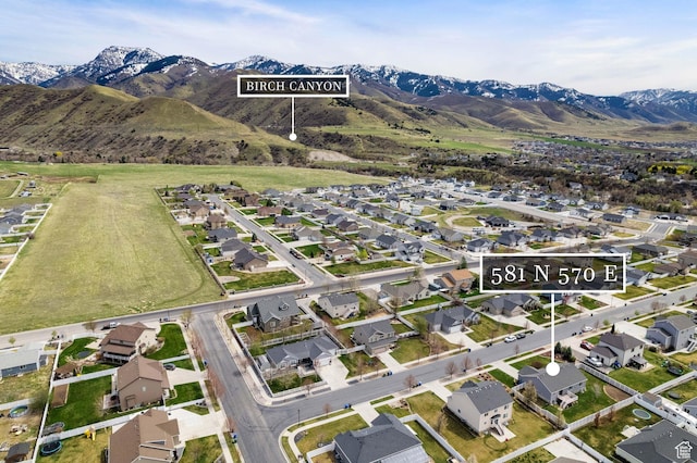 drone / aerial view with a residential view and a mountain view