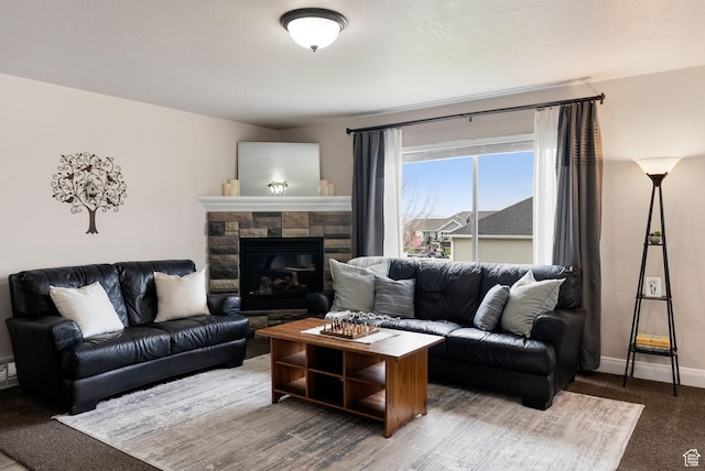 living area featuring carpet flooring, a fireplace, and baseboards