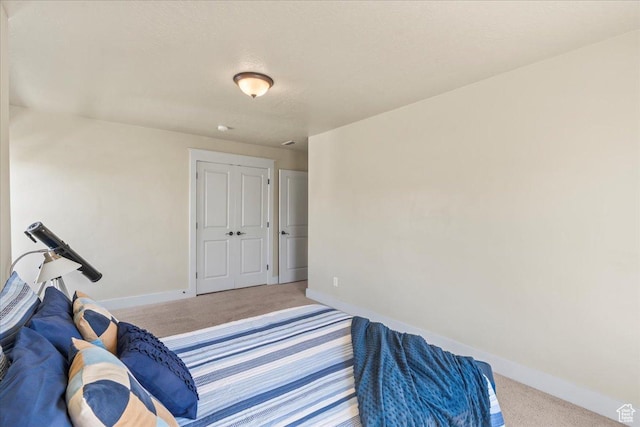 bedroom with baseboards and carpet