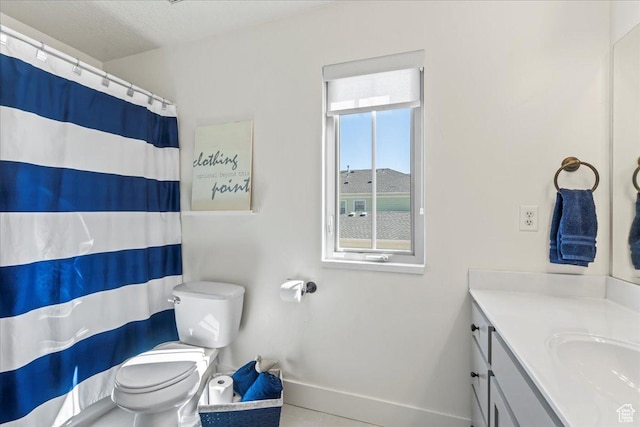 full bath with curtained shower, vanity, baseboards, and toilet