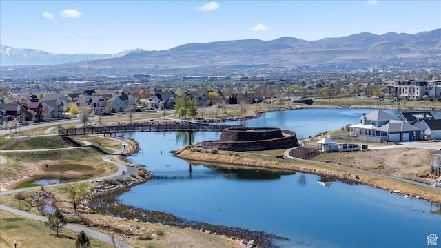 drone / aerial view featuring a water and mountain view and a residential view