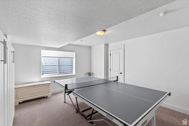 playroom featuring baseboards, carpet flooring, and a textured ceiling