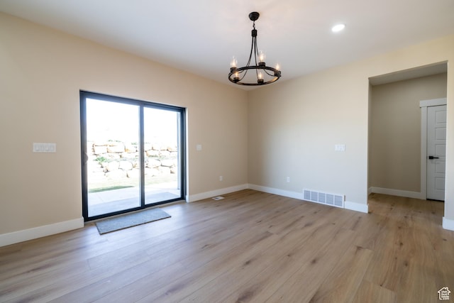 2899 E Lake Dr, Eagle Mountain, UT 84005 - unfurnished room featuring light wood-style floors, a notable chandelier, baseboards, and visible vents