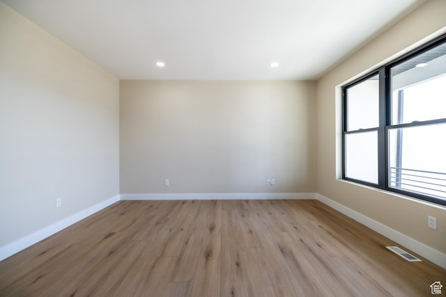 2899 E Lake Dr, Eagle Mountain, UT 84005 - spare room with light wood-style floors, plenty of natural light, visible vents, and baseboards