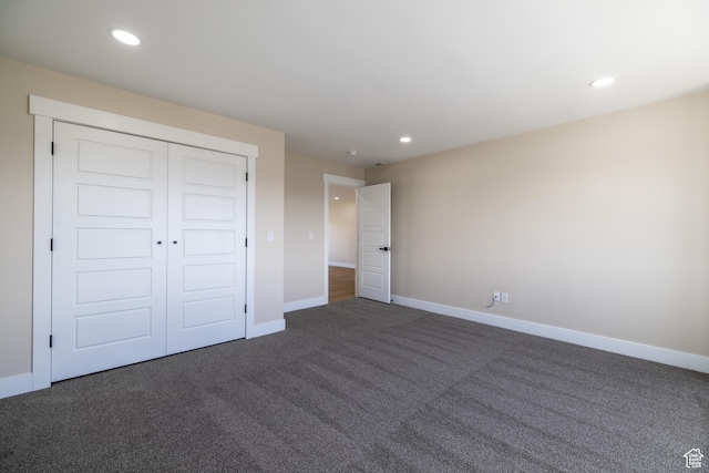 2899 E Lake Dr, Eagle Mountain, UT 84005 - unfurnished bedroom featuring a closet, dark colored carpet, baseboards, and recessed lighting