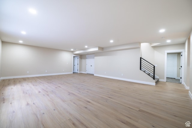 2899 E Lake Dr, Eagle Mountain, UT 84005 - below grade area with recessed lighting, stairway, light wood-style flooring, and baseboards