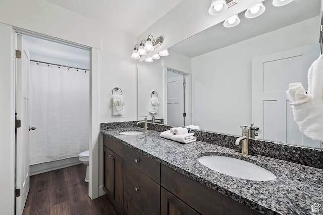 2250 S Beachcomber Ln, Garden City, UT 84028 - full bathroom featuring double vanity, a sink, toilet, and wood finished floors