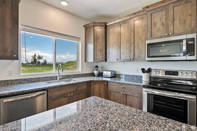 2250 S Beachcomber Ln, Garden City, UT 84028 - kitchen with stone countertops, a sink, and appliances with stainless steel finishes