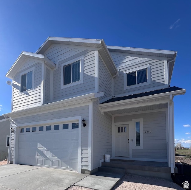 2250 S Beachcomber Ln, Garden City, UT 84028 - view of front of home featuring an attached garage, driveway, and a porch