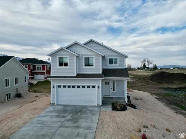 2250 S Beachcomber Ln, Garden City, UT 84028 - traditional home with a shingled roof, a garage, and concrete driveway
