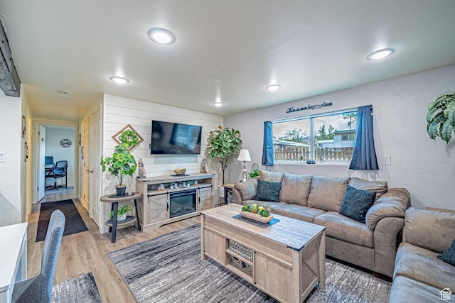 524 Westwood Ave, Moab, UT 84532 - living area with light wood-style flooring, a glass covered fireplace, and recessed lighting