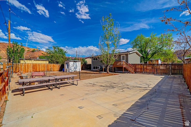 524 Westwood Ave, Moab, UT 84532 - view of patio featuring a fenced backyard, an outdoor structure, and a storage unit