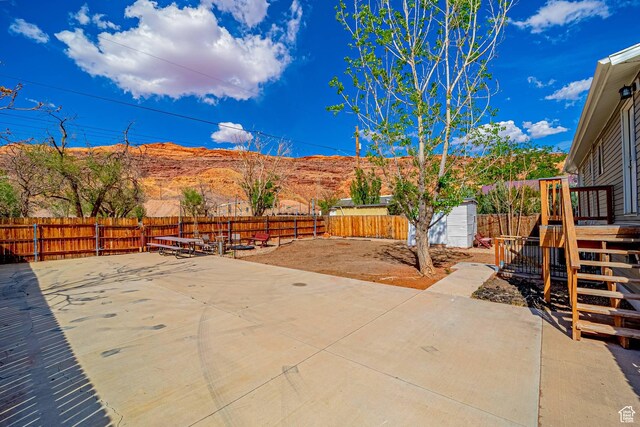 524 Westwood Ave, Moab, UT 84532 - view of patio featuring an outbuilding, a fenced backyard, and a mountain view