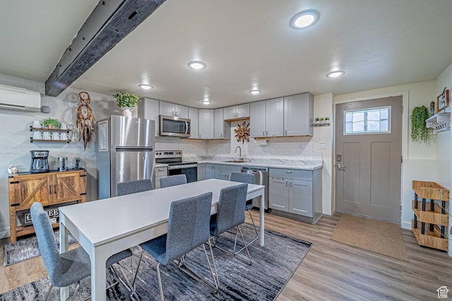 524 Westwood Ave, Moab, UT 84532 - kitchen featuring tasteful backsplash, a sink, recessed lighting, stainless steel appliances, and a wall unit AC