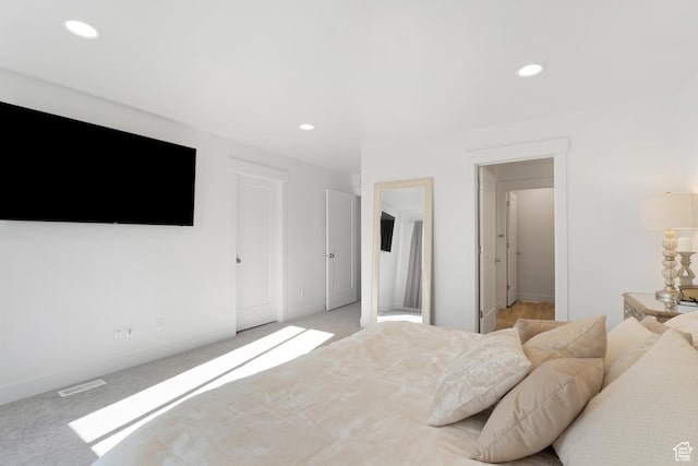 bedroom featuring baseboards, recessed lighting, and light carpet