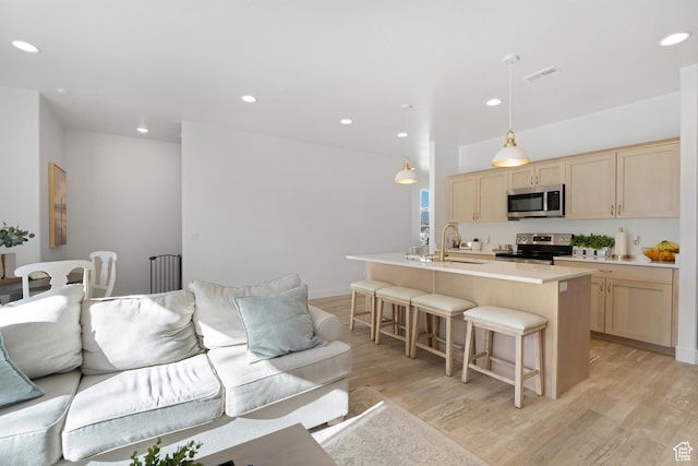 living room with light wood-type flooring and recessed lighting