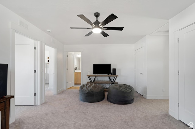 living area with carpet flooring, ceiling fan, and baseboards