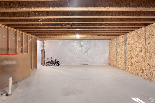unfinished basement featuring water heater