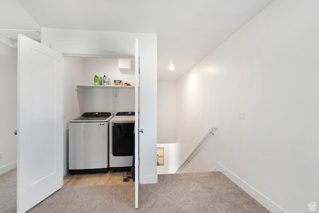 clothes washing area featuring washing machine and dryer, light carpet, baseboards, and recessed lighting