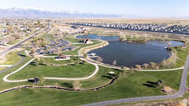 view of property location featuring a water and mountain view and nearby suburban area
