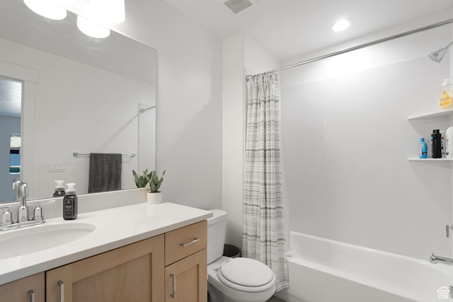 bathroom featuring toilet, shower / bath combo, and vanity