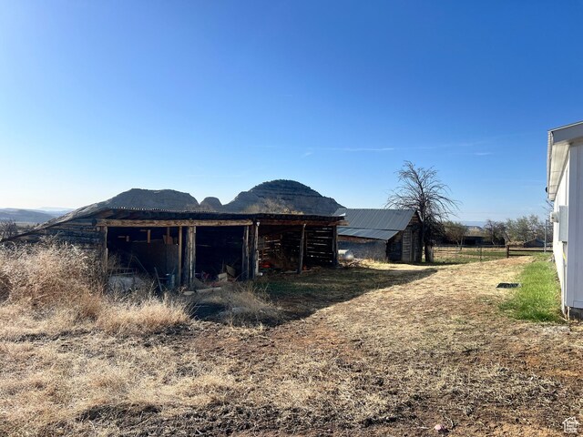 view of outbuilding featuring a mountain view and an outdoor structure
