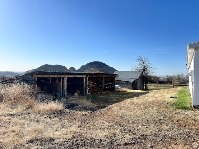 view of outbuilding featuring a mountain view and an outdoor structure