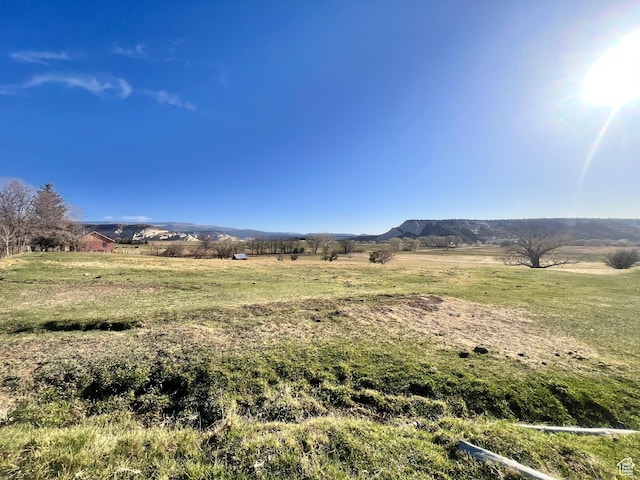 view of mountain background featuring rural landscape