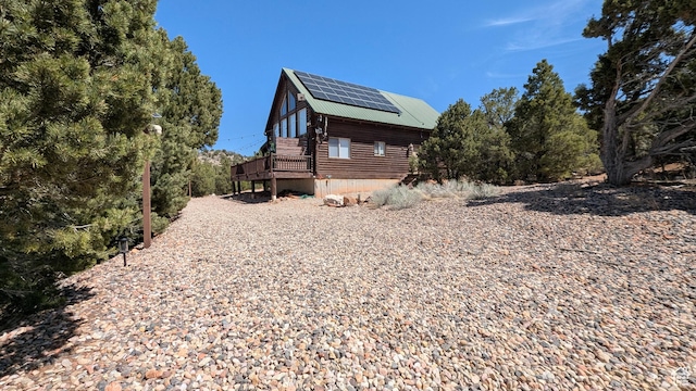 1741 S Red Canyon Dr, Parowan, UT 84761 - view of side of property featuring metal roof, a wooden deck, and solar panels
