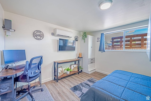 524 Westwood Ave, Moab, UT 84532 - bedroom with a wall mounted air conditioner, a desk, and wood finished floors