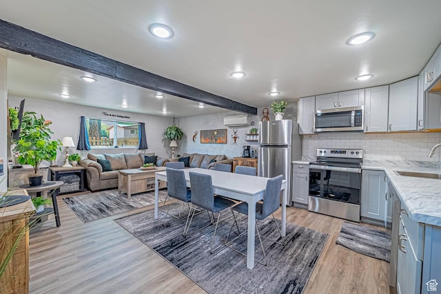 524 Westwood Ave, Moab, UT 84532 - dining space featuring a wall mounted AC, light wood-style floors, beamed ceiling, and recessed lighting