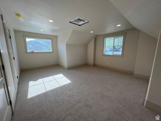 177 E 475 S, Mantua, UT 84324 - additional living space featuring light colored carpet, lofted ceiling, baseboards, recessed lighting, and a textured ceiling