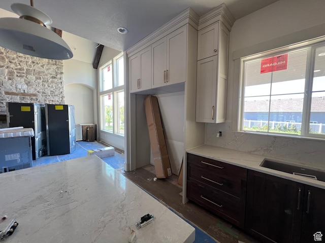 177 E 475 S, Mantua, UT 84324 - kitchen featuring light stone countertops, wood finished floors, vaulted ceiling, and white cabinets