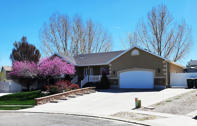 6723 W Hunter Farm Cir S, West Valley City, UT 84128 - ranch-style house featuring a garage, stucco siding, driveway, and stone siding