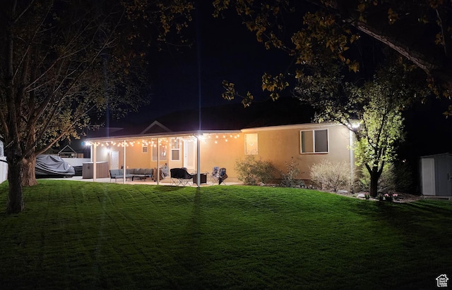 6723 W Hunter Farm Cir S, West Valley City, UT 84128 - view of front facade featuring a patio area, a lawn, stucco siding, and an outdoor hangout area