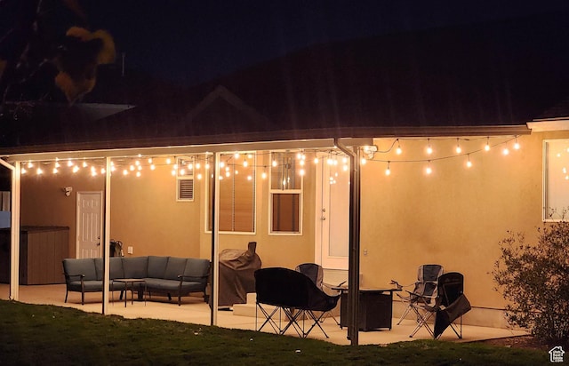 6723 W Hunter Farm Cir S, West Valley City, UT 84128 - back of house at twilight featuring a patio area, an outdoor hangout area, stucco siding, and a hot tub